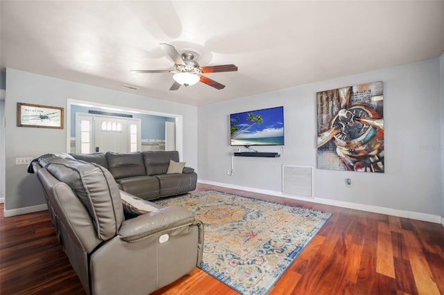 living area with ceiling fan, visible vents, baseboards, and wood finished floors