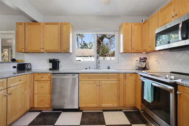 kitchen with backsplash, light floors, stainless steel appliances, and a sink