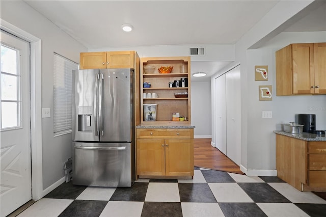 kitchen featuring open shelves, stainless steel fridge with ice dispenser, dark floors, and baseboards