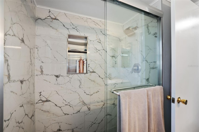 bathroom featuring a marble finish shower and crown molding