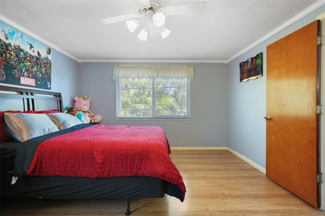 bedroom with ornamental molding, ceiling fan, baseboards, and wood finished floors