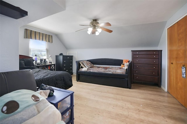 bedroom with baseboards, light wood-style flooring, a ceiling fan, and vaulted ceiling