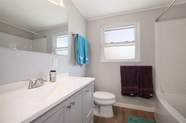 bathroom featuring baseboards, toilet, shower / tub combination, wood finished floors, and vanity