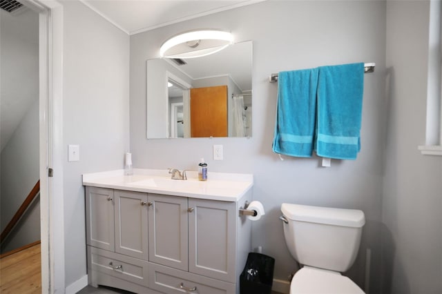 full bath featuring vanity, toilet, visible vents, and ornamental molding