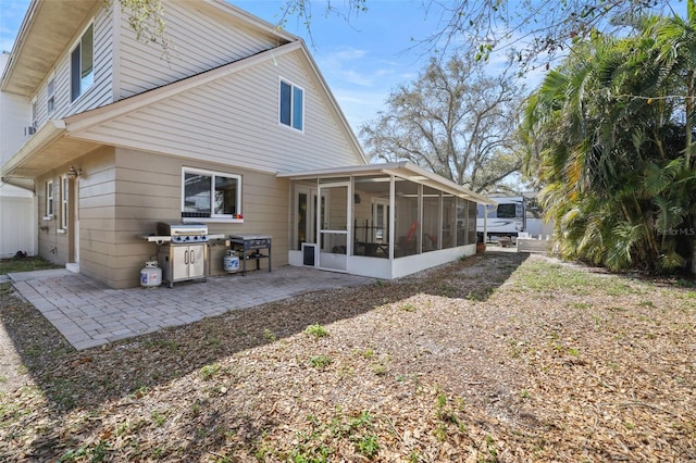 back of house featuring a patio area and a sunroom