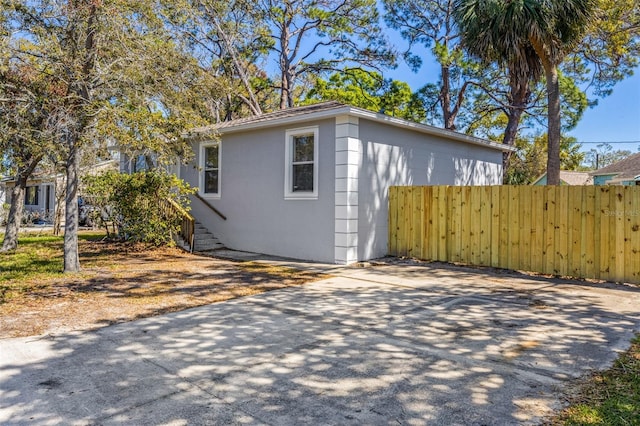 view of outbuilding with fence