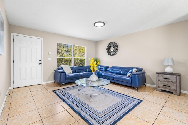 living area with light tile patterned floors and baseboards