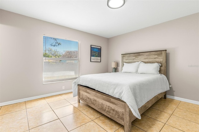 bedroom featuring light tile patterned flooring and baseboards