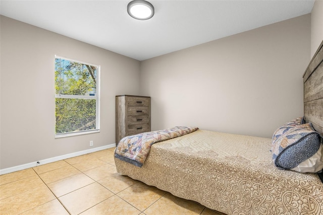 tiled bedroom featuring baseboards