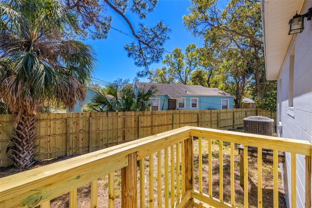 deck featuring cooling unit and fence