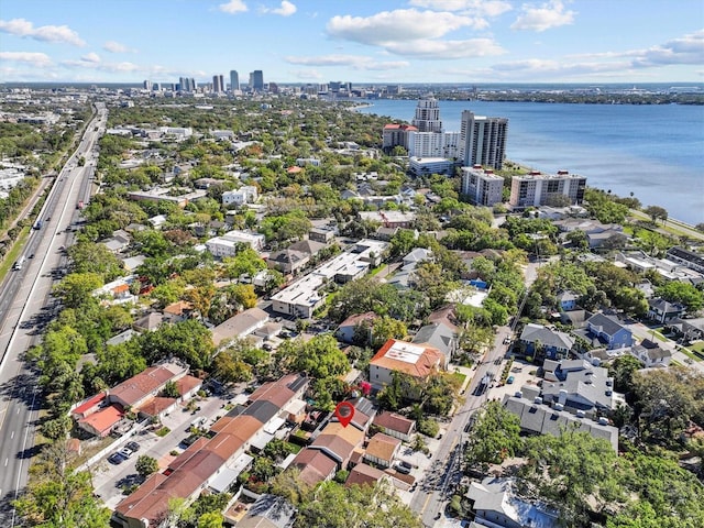 birds eye view of property with a view of city and a water view