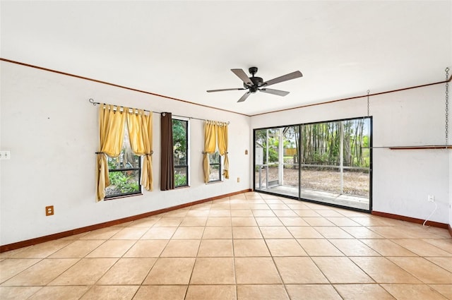 unfurnished room featuring light tile patterned floors, baseboards, and a ceiling fan