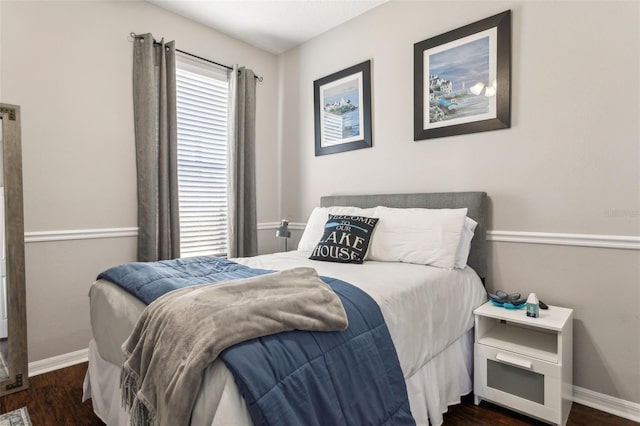 bedroom with wood finished floors and baseboards