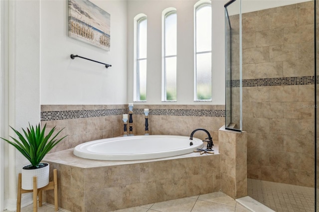 full bathroom featuring tile patterned floors, a garden tub, and a tile shower