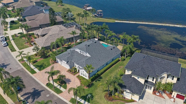 birds eye view of property with a water view and a residential view