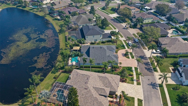 drone / aerial view with a residential view and a water view