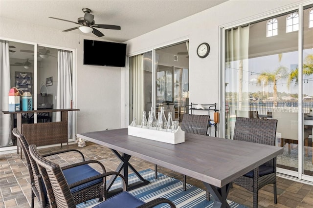 view of patio / terrace with outdoor dining area and a ceiling fan