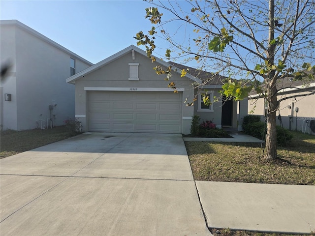 view of front of house with stucco siding, concrete driveway, and an attached garage