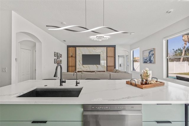 kitchen featuring a sink, plenty of natural light, dishwasher, and open floor plan