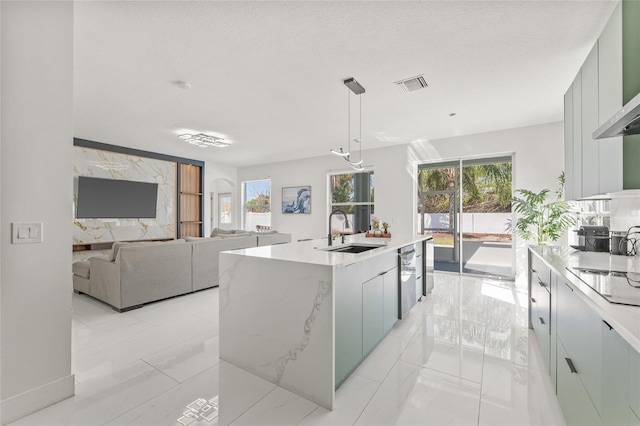 kitchen featuring a wealth of natural light, visible vents, a sink, wall chimney range hood, and black electric stovetop