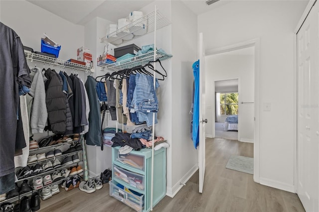 spacious closet featuring visible vents and wood finished floors