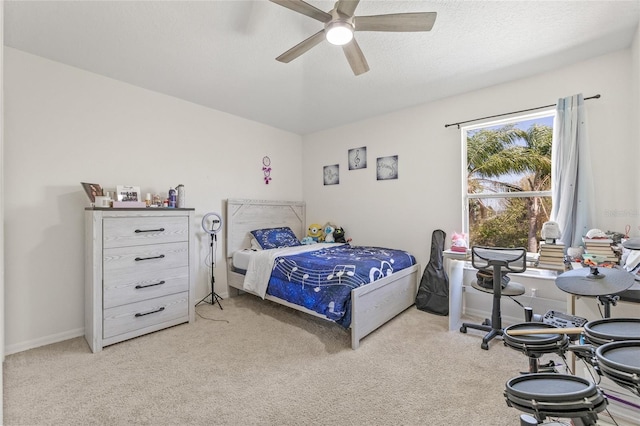 bedroom with carpet flooring, a ceiling fan, baseboards, and a textured ceiling