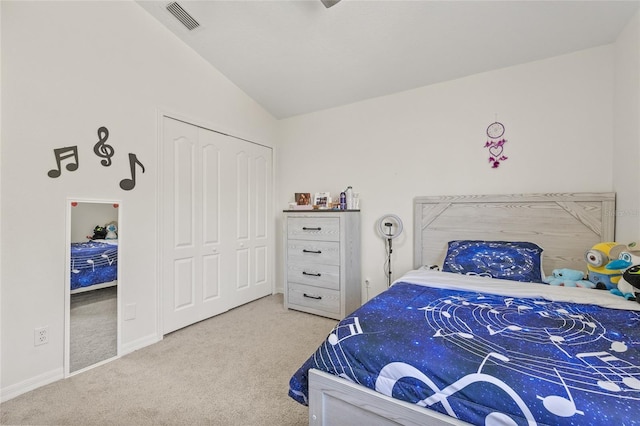 carpeted bedroom featuring visible vents, baseboards, a closet, and vaulted ceiling