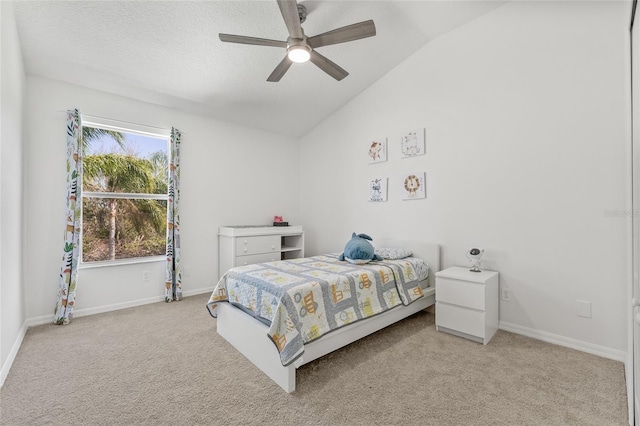 bedroom featuring a ceiling fan, baseboards, carpet floors, lofted ceiling, and a textured ceiling