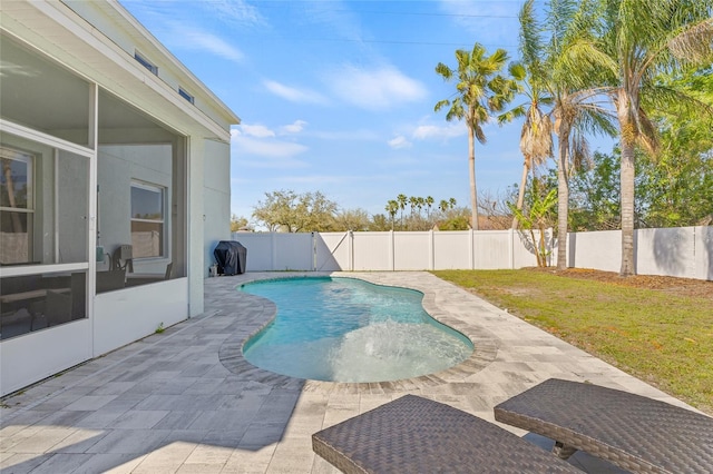 view of swimming pool featuring a fenced in pool, a yard, a fenced backyard, a patio area, and area for grilling