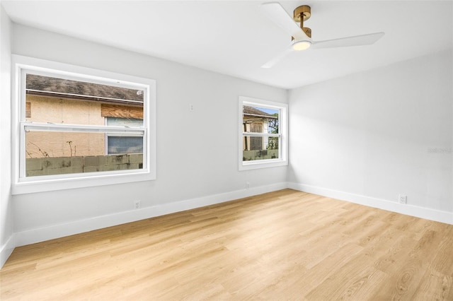 spare room with ceiling fan, baseboards, and wood finished floors