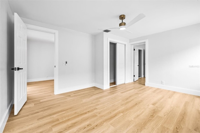 spare room featuring light wood-type flooring, baseboards, and visible vents