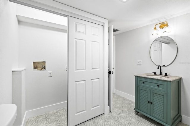 bathroom with visible vents, vanity, and baseboards