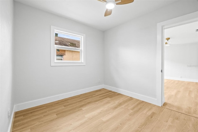 empty room featuring baseboards, light wood-style floors, and a ceiling fan