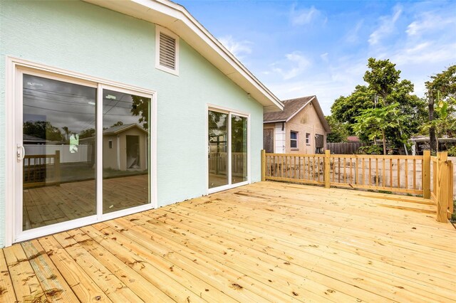 wooden terrace featuring fence