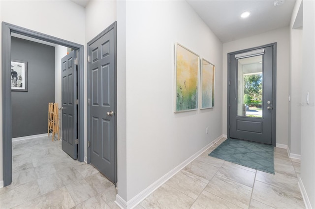 foyer featuring recessed lighting, baseboards, and marble finish floor