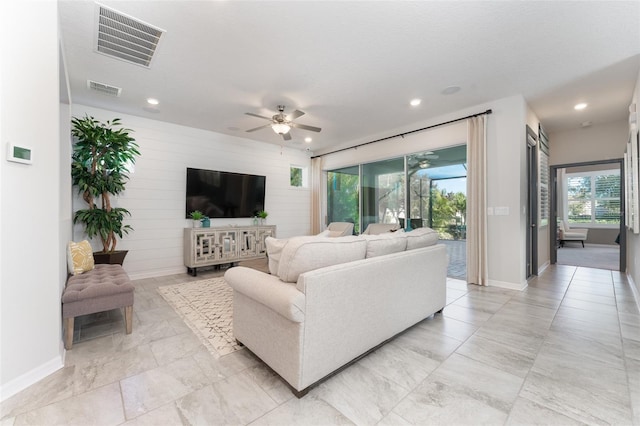 living room with recessed lighting, visible vents, and a ceiling fan