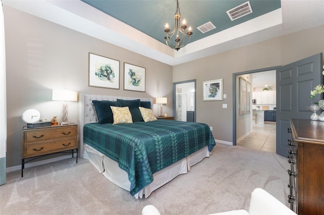 bedroom with visible vents, a raised ceiling, and light carpet