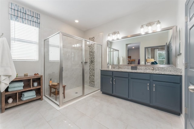 full bath with vanity and a shower stall