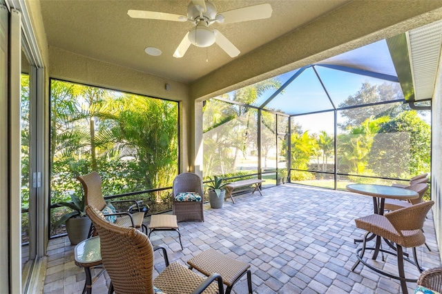 sunroom with a healthy amount of sunlight and a ceiling fan