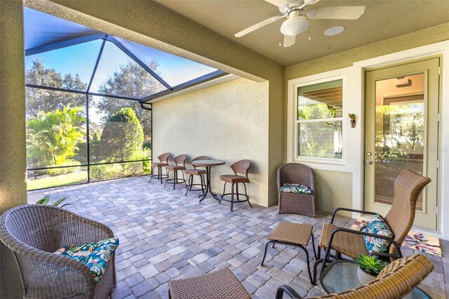 sunroom featuring a ceiling fan