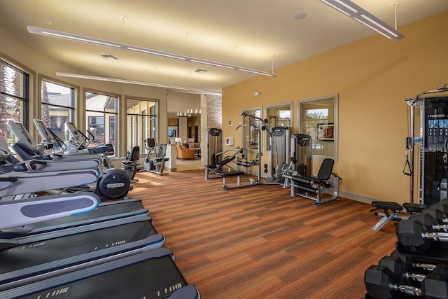 gym with baseboards and visible vents