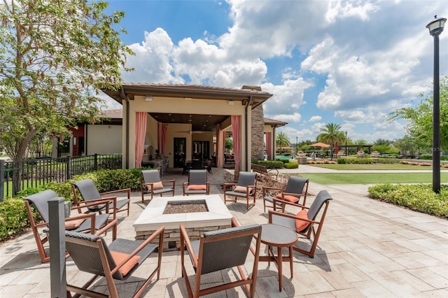 view of patio with a fire pit and fence