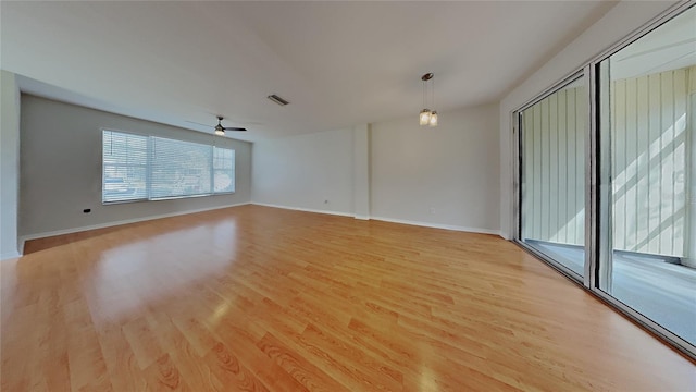 unfurnished room featuring visible vents, baseboards, light wood-type flooring, and ceiling fan