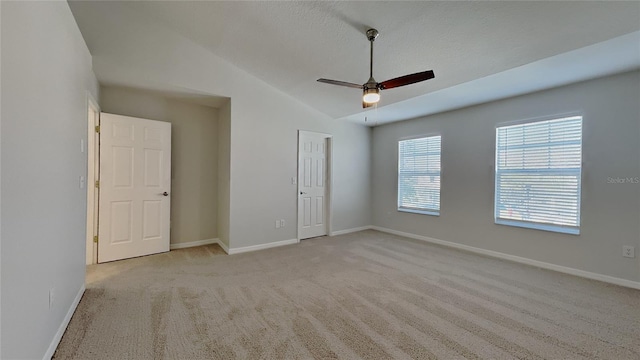 unfurnished room featuring lofted ceiling, baseboards, and carpet floors