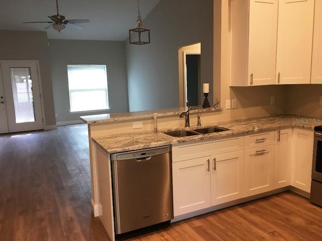 kitchen featuring dishwasher, light stone counters, open floor plan, and a sink