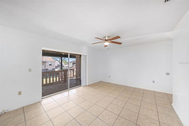 spare room featuring light tile patterned floors and a ceiling fan