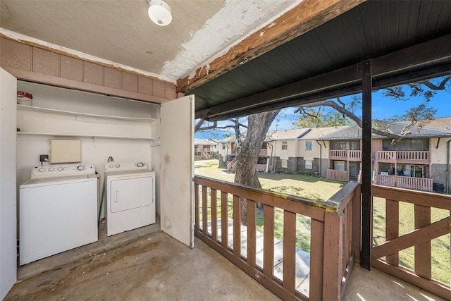 laundry area featuring laundry area, independent washer and dryer, and a residential view