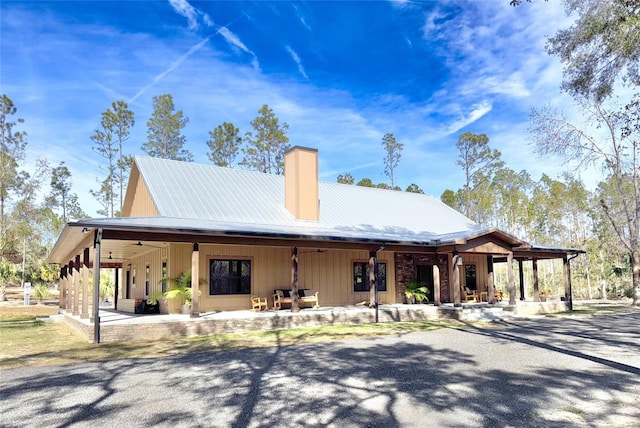 view of front of home with metal roof and a chimney