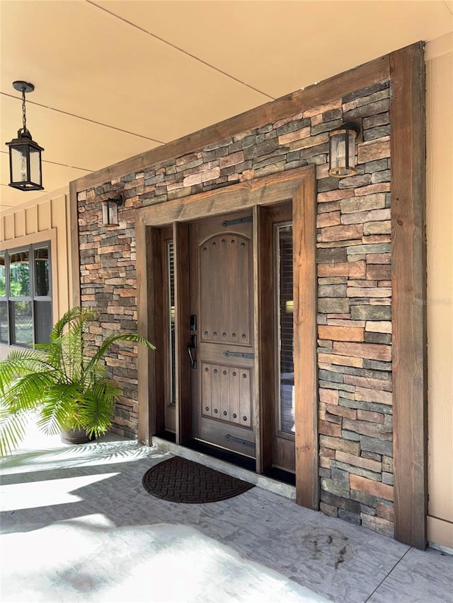 doorway to property featuring stone siding