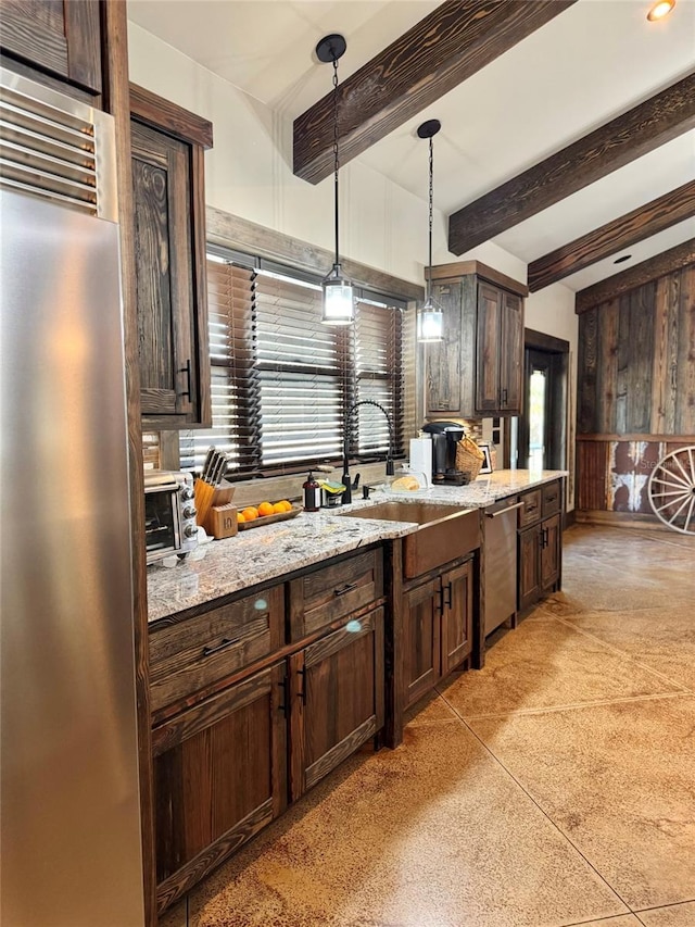 kitchen with stainless steel appliances, beam ceiling, dark brown cabinetry, and light stone countertops